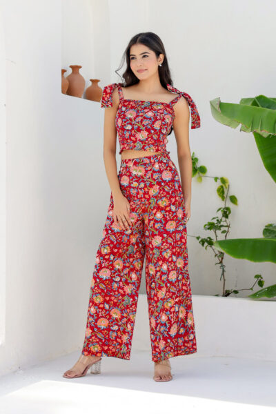Model wearing Bolbo Cherry Crush red floral coord set with tie-shoulder crop top and wide-leg pants – front view.